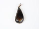 a close up of a tear shaped pendant on a white surface