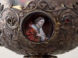 a silver bowl with a picture of a woman on it