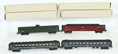 four toy trains in a display case on a white surface