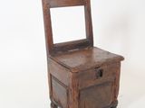 an old wooden chair sitting on top of a white surface