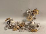 pair of gold and clear glass flower earrings on a white surface