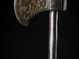 a close up of a metal axe on a black background