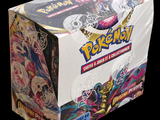 the box is full of a variety of pokemon cards on a black background