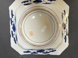 a close up of a blue and white bowl on a table
