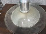 a metal lamp that is sitting on a wooden table