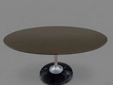 a round glass table with a black base and a metal base