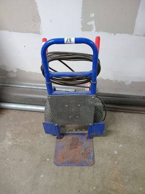 un diable bleu auquel est fixé un tuyau