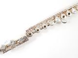 a flute that is sitting on a white surface