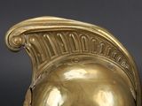 a gold vase with a helmet on top of it