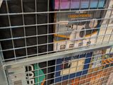 a metal cart with magazines on it in a store