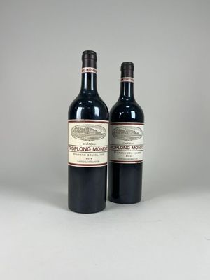 two bottles of red wine sitting next to each other on a table