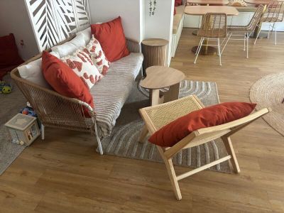 a living room with a couch, chairs and a table