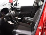 the interior of a red car with black seats and a steering wheel
