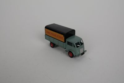 a toy truck that is sitting on a white surface