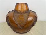 a brown vase sitting on a table with a white background