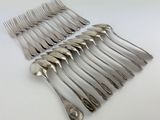 a lot of forks and spoons sitting on a table