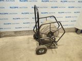 an image of a hand truck with a hose on it