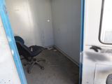 a blue chair sitting in the corner of a room