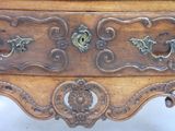a wooden chest of drawers with ornate carvings on it