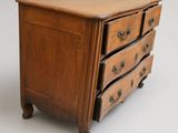 a small wooden chest of drawers on a white background