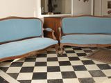 two couches and a chair in a room with a checkered floor