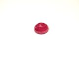 a small red object on a white surface with a white background