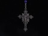 a close up of a cross with a purple bead on it
