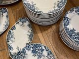 blue and white china plates and bowls on a wooden table
