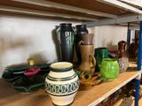 many vases on a shelf in a room