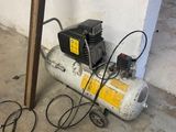 an image of a small air compressor in a garage