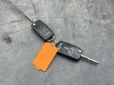 a car key and a keychain laying on the floor