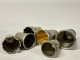 five silver vases sitting next to each other on a white surface