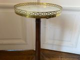 a small table with a glass top sitting on a wooden floor