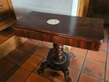 a wooden table with a white flower on top of it