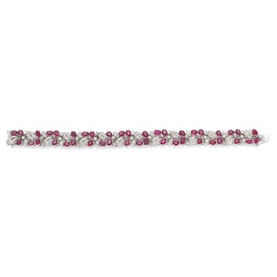 a close up of a pink and white bracelet on a white background