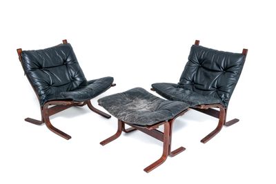 pair of black leather lounge chairs and ottoman on wooden legs