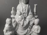 chinese porcelain figurine of a woman holding a baby and three birds
