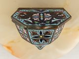 a small decorative box on the wall with a flower design