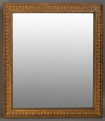 a gold framed mirror on a gray wall
