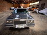 a car that is parked in a garage next to other cars