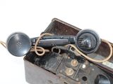 an old fashioned telephone sitting in a box on a table
