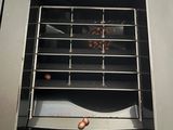 a person taking a piece of food out of a toaster oven