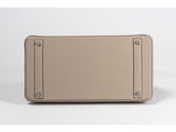 an image of a beige suitcase sitting on top of a white surface