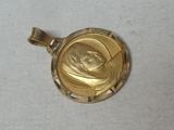 a picture of a gold pendant with a picture of a woman on it