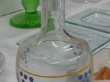 a bottle of water sitting on a table next to a plate of food