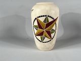 un vase blanc orné d'un motif en forme d'étoile