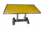 table with yellow glass top and metal legs