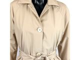 a women ' s beige trench coat with a belt on a mannequin mannequin mannequin mannequin mannequin mannequin manne