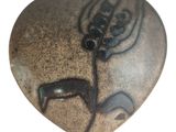 a heart shaped rock with a picture of a deer on it