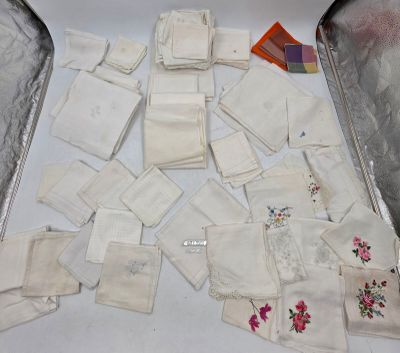 plusieurs morceaux de tissu posés sur la table, à côté d'une valise